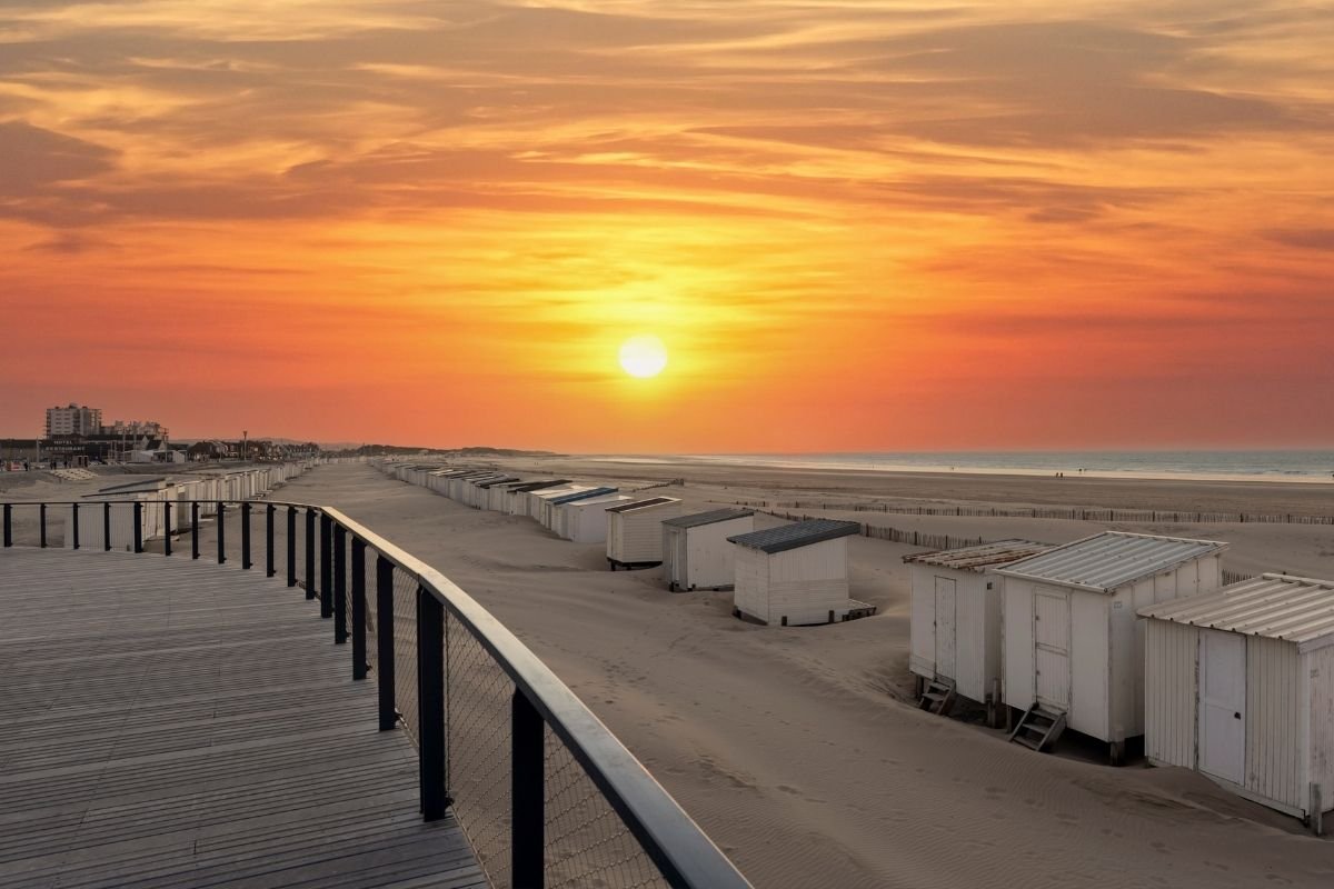 Sunset over Calais beach and its wooden promenade
