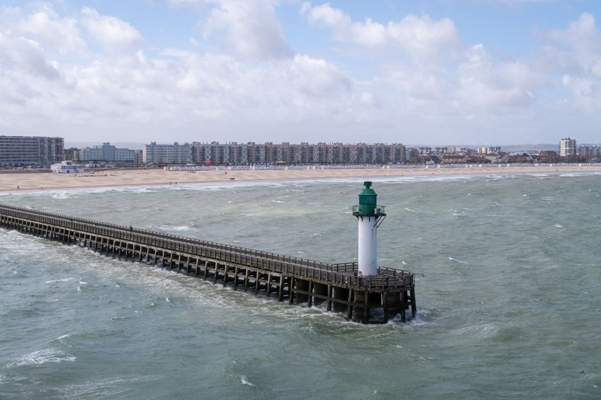 The white Calais Lighthouse rising above the surrounding buildings